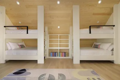 two bunk beds in a room with wooden ceilings at Sky House chalet in Tabernash