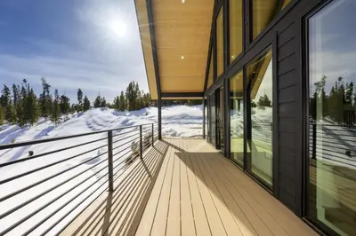 a balcony of a house with snow on the ground at Sky House chalet in Tabernash