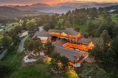 an aerial view of a house with mountains in the background at Mountain Top Luxury Red Rocks Hot tub Sauna Views in Golden