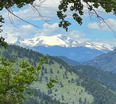 a view of a snow covered mountain in a valley at Mountain Top Luxury Red Rocks Hot tub Sauna Views in Golden
