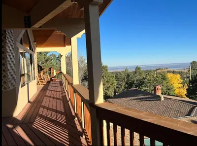 a balcony of a house with a view of the countryside at Mountain Top Luxury Red Rocks Hot tub Sauna Views in Golden