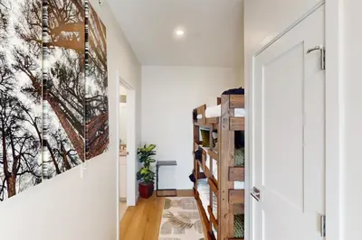 a hallway with a staircase with a painting on the wall at Sunnyside Up in Fraser