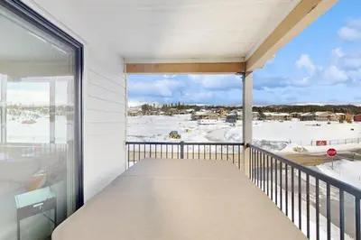a balcony with a view of the snow at Sunnyside Up in Fraser