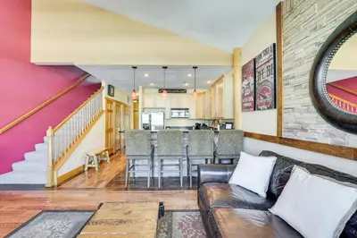 a living room with a couch and a table at 4 Mi to Ski Dillon Condo with Balcony and Mtn Views in Dillon