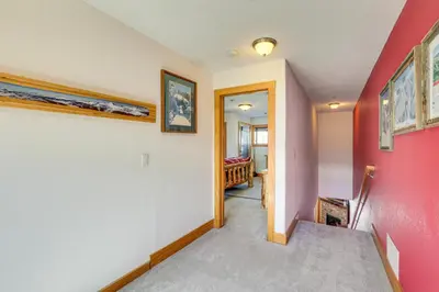 a hallway with pink and white walls at 4 Mi to Ski Dillon Condo with Balcony and Mtn Views in Dillon