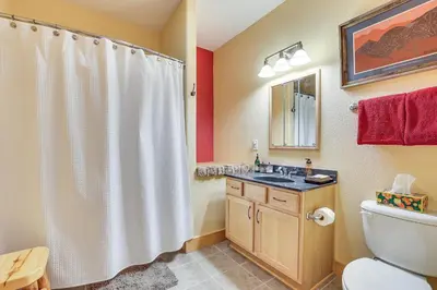 a bathroom with a toilet and a sink and a shower at 4 Mi to Ski Dillon Condo with Balcony and Mtn Views in Dillon