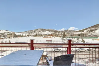 a table and two chairs on a balcony with snow at 4 Mi to Ski Dillon Condo with Balcony and Mtn Views in Dillon