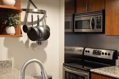 a kitchen with a stove and a microwave at Urban Gallery Loft - King Bed - Larimer Square in Denver