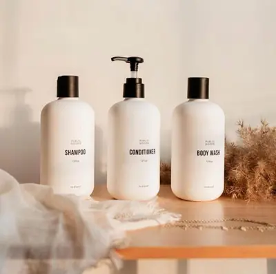 three bottles of shampoo and conditioner sitting on a table at Urban Gallery Loft - King Bed - Larimer Square in Denver