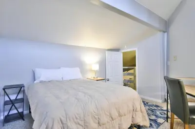 a bedroom with a bed and a table and a chair at Wild Irishman Off-Piste Condo: Great Keystone Getaway in Keystone