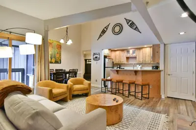 a living room and kitchen with a couch and a table at Wild Irishman Off-Piste Condo: Great Keystone Getaway in Keystone