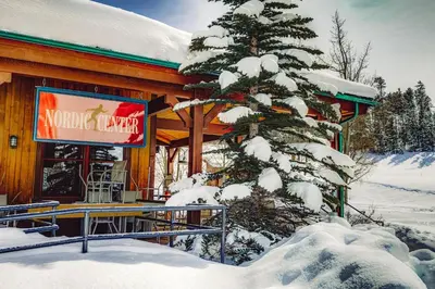 a snow covered tree in front of a building at Wild Irishman Off-Piste Condo: Great Keystone Getaway in Keystone