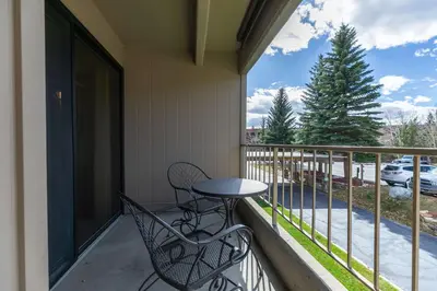 a balcony with a table and chairs on a porch at Lodge at Lake Dillon Condo: Great Year-Round Location in Dillon