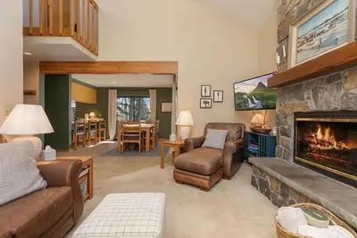 a living room with a fireplace and a couch and chairs at Frisco Mountainside Retreat: Walk Downtown in Frisco