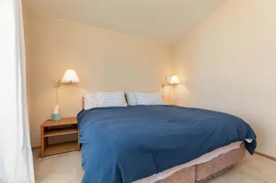 a bedroom with a bed with a blue blanket on it at Frisco Mountainside Retreat: Walk Downtown in Frisco