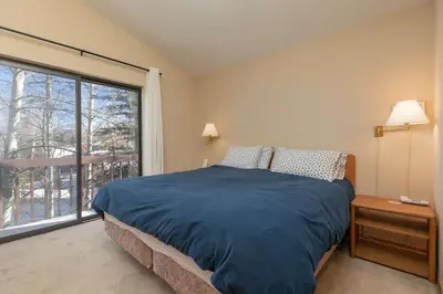 a bedroom with a bed and a large window at Frisco Mountainside Retreat: Walk Downtown in Frisco