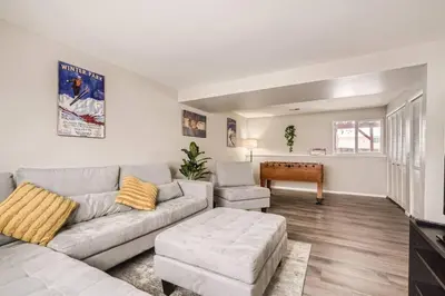 a living room with a couch and a table at Centrally located for adventures in Westminster
