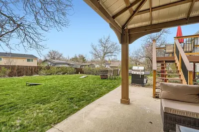 a backyard with a deck and a yard with a playground at Centrally located for adventures in Westminster