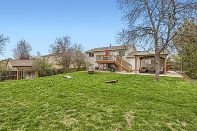 a large yard with a house in the background at Centrally located for adventures in Westminster