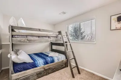 a bedroom with a bunk bed with a ladder at Centrally located for adventures in Westminster