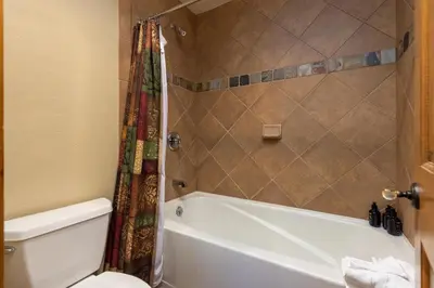 a bathroom with a white tub and a toilet at 6533 Settlers Creek townhouse in Keystone