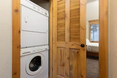 a washer and dryer in a room with a door at 6533 Settlers Creek townhouse in Keystone