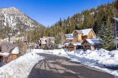 a street covered in snow with houses and trees at 6533 Settlers Creek townhouse in Keystone