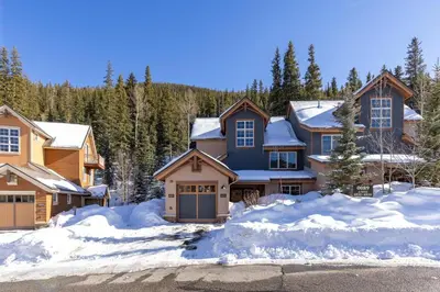 a house with snow in front of it at 6533 Settlers Creek townhouse in Keystone