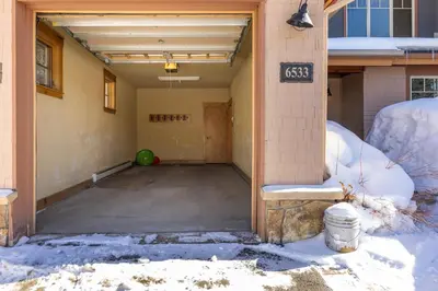 an empty garage with snow on the ground at 6533 Settlers Creek townhouse in Keystone
