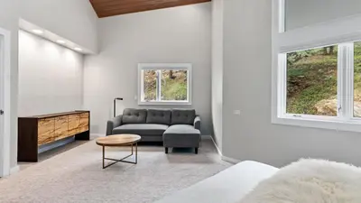 a living room with a couch and a table at Casa de Cristal-Epic Views-HotTub-Sauna-Sleeps 10-Luxury Linens-Stocked Kitchen in Estes Park