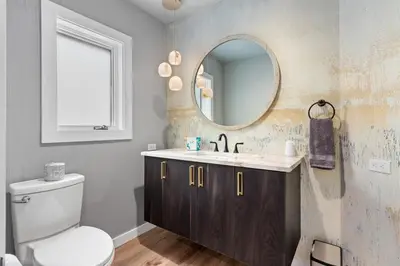 a bathroom with a sink and a toilet and a mirror at Casa de Cristal-Epic Views-HotTub-Sauna-Sleeps 10-Luxury Linens-Stocked Kitchen in Estes Park