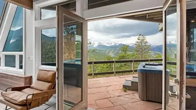 a patio with a view of the mountains at Casa de Cristal-Epic Views-HotTub-Sauna-Sleeps 10-Luxury Linens-Stocked Kitchen in Estes Park