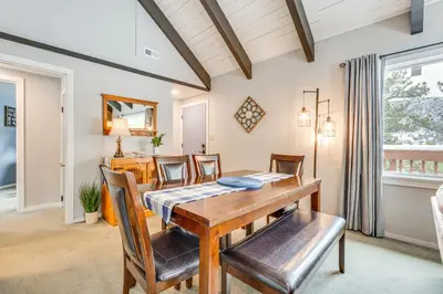 a dining room with a table and chairs at Cozy Estes Park Condo with Balcony and Fireplace! in Estes Park