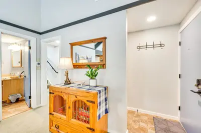 a bathroom with a mirror and a wooden dresser at Cozy Estes Park Condo with Balcony and Fireplace! in Estes Park