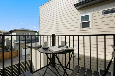 a balcony with a table with a book on it at Exquisite Home by Old Town - Steps from Poudre Trail in Fort Collins