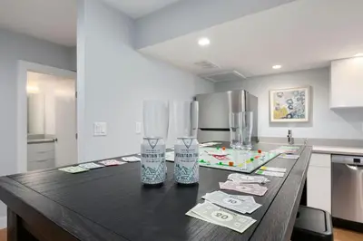 a kitchen counter with two glasses and money on it at Exquisite Home by Old Town - Steps from Poudre Trail in Fort Collins