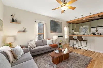 a living room with a couch and a table at The Hattie House in Old Town - Walk Everywhere! in Fort Collins