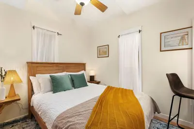 a bedroom with a bed and a ceiling fan at The Hattie House in Old Town - Walk Everywhere! in Fort Collins
