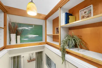 a home office with wooden shelves and a window at The Hattie House in Old Town - Walk Everywhere! in Fort Collins