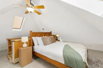 a bedroom with a bed and a ceiling fan at The Hattie House in Old Town - Walk Everywhere! in Fort Collins