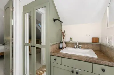 a bathroom with a sink and a mirror at The Hattie House in Old Town - Walk Everywhere! in Fort Collins