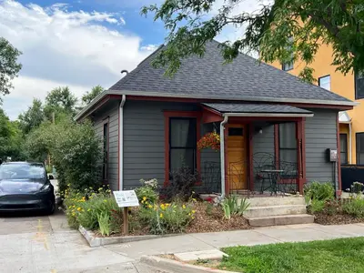a small house with a car parked in the driveway at The Hattie House in Old Town - Walk Everywhere! in Fort Collins