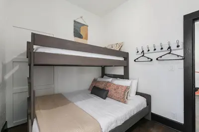 a bedroom with a bunk bed in a room at Old Town Retreat with Hot Tub - Steps from CSU! in Fort Collins