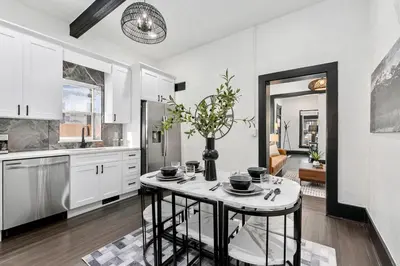 a kitchen with a table with a vase on it at Old Town Retreat with Hot Tub - Steps from CSU! in Fort Collins
