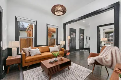 a living room with a couch and a table at Old Town Retreat with Hot Tub - Steps from CSU! in Fort Collins