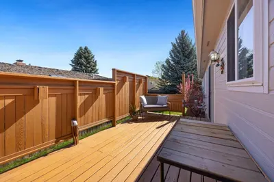 a wooden deck with a chair on a house at Charming Home with RV Parking - 30 miles from RMNP! in Loveland