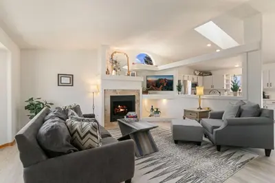 a living room with two couches and a fireplace at Charming Home with RV Parking - 30 miles from RMNP! in Loveland