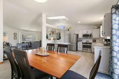 a kitchen and dining room with a wooden table and chairs at Charming Home with RV Parking - 30 miles from RMNP! in Loveland