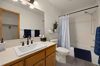a bathroom with a sink and a toilet and a mirror at Charming Home with RV Parking - 30 miles from RMNP! in Loveland