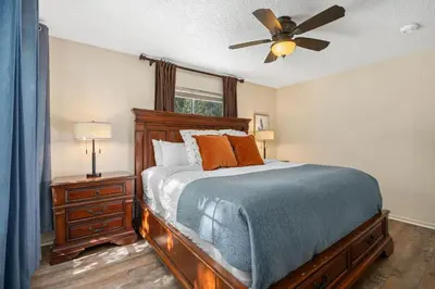 a bedroom with a bed and a ceiling fan at Close to Trails, Parks & Open Space! Amazing Yard! in Fort Collins